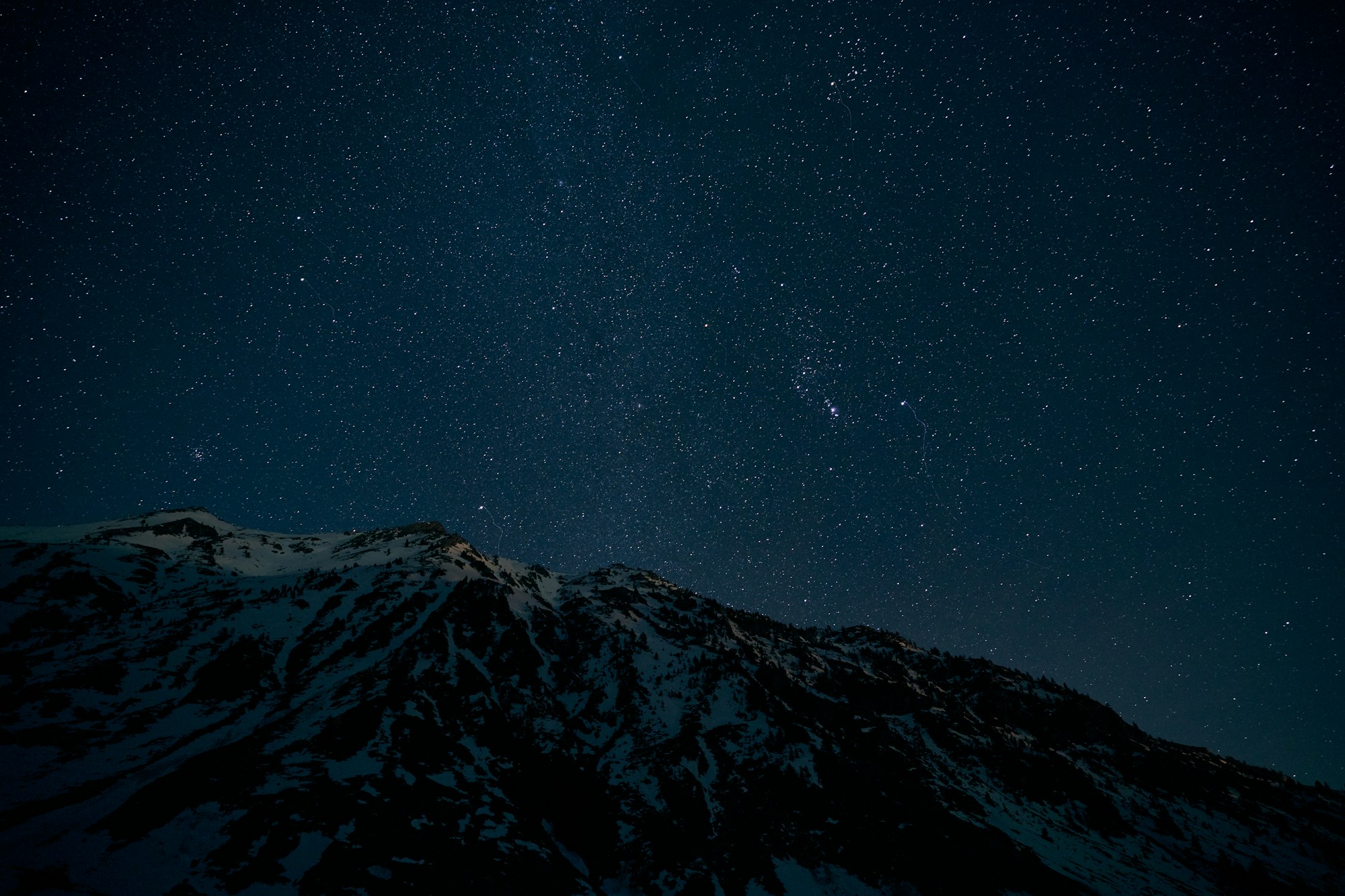 Snowy mountain ridge at night